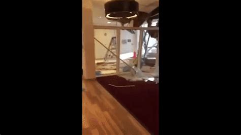 man destroys office with mini excavator|Watch as disgruntled construction worker destroys U.K. hotel .